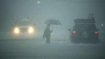A man walks in heavy rain in Houston, Texas on Aug 27 