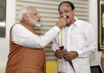 PM Modi offers sweets to VP-elect Venkaiah Naidu at his residence in New Delhi