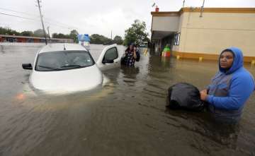 A stuck car in rising floodwaters from Tropical Storm Harvey in Houston, Texas