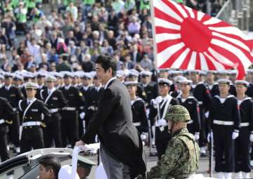FILE - PM Shinzo Abe reviews members of Japan Self-Defense Forces 