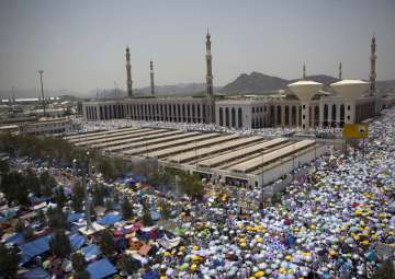 Muslim pilgrims attend noon prayers outside the Namirah mosque in Mecca