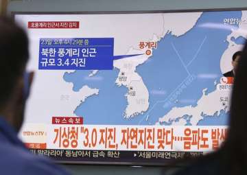 Seoul: People watch a TV news program reporting North Korea’s earthquake