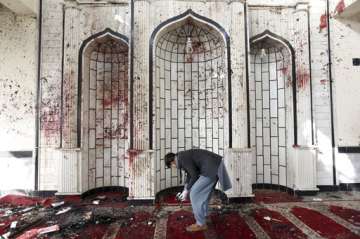 An Afghan man inspects inside a damaged mosque in Kabul, Afghanistan.