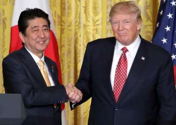 File pic - Donald Trump congratulates Japan PM Shinzo Abe on poll victory