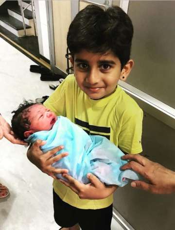 Murali Vijay's elder son with new born baby.