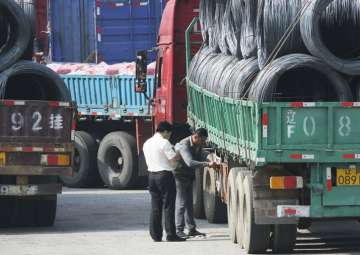 File - Chinese custom officials inspect trucks loaded with goods to and from North Korea in Dandong

