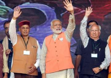 PM Modi, chief ministerial candidate PK Dhumal and senior BJP leader Shanta Kumar at an election rally in Kangra