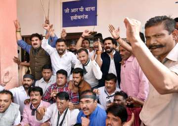 Congress workers stage a protest against the gangrape of a student, at the Government Railways police station in Bhopal on Friday