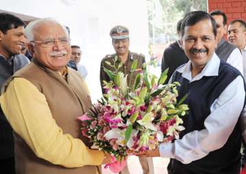 Manohar Lal greets Arvind Kejriwal before a meeting in Chandigarh on Wednesday