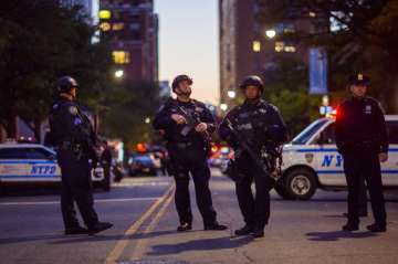 
Heavily armed police stand guard near the scene after a motorist drove onto a busy bicycle path near the World Trade Center memorial and struck several people.