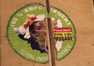 An old torn election sticker, with a portrait of Zimbabwean President Robert Mugabe, on a building in Harare on Sunday