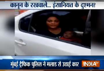 Mumbai traffic cop tow away car with woman breastfeeding infant