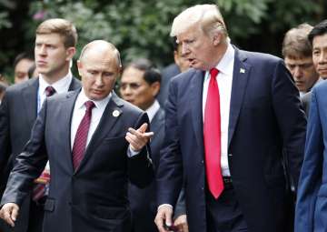 Donald Trump and Vladimir Putin talk during the family photo session at the APEC Summit in Danang