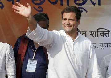 Congress vice-president Rahul Gandhi waves to supporters during a rally at Nani Devati village of Sanand