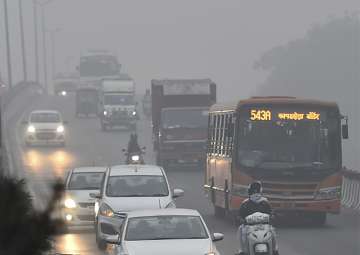 File pic - Vehicles plying at a road in smog in New Delhi