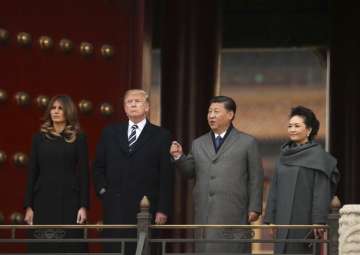 Donald Trump, first lady Melania Trump, Xi Jinping and his wife Peng Liyuan stand together as they tour the Forbidden City