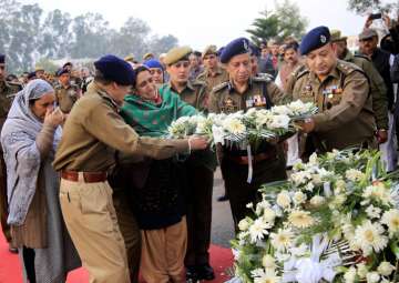 Wife of martyr Sub Inspector Imran Tak, who was killed in a militant attack in Zakura on the outskirts of Srinagar, wails during the wreath laying ceremony

