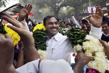 Former Telecom minister A Raja reacts as he celebrates along with his supporters after he was acquitted by a special court in the 2G scam case