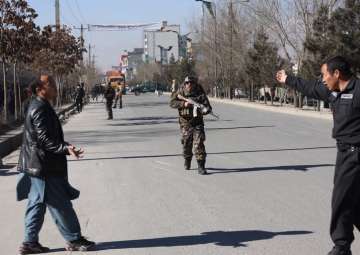 Security personnel arrive outside the site of a suicide attack in Kabul