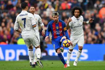 Messi dribbles past Ronaldo in the El Clasico.