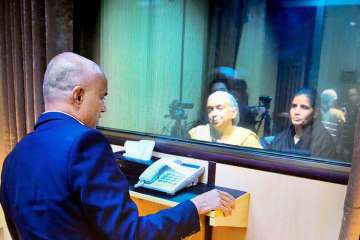 Former Indian Navy officer Kulbhushan Jadhav's wife and mother meet him while seated across a glass partition at the Pakistan Foreign Office in Islamabad on Monday. 