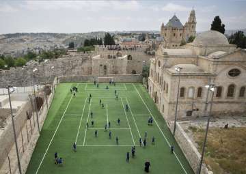 Armenian school kids play in the soccer field located next to Jerusalem’s Old City Walls at the Sts. Tarkmanchatz Armenian School of Jerusalem