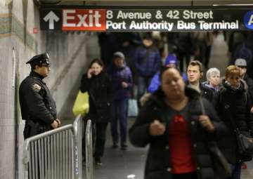 A police officer stands in the passageway connecting New York City’s Port Authority bus terminal and the Times Square subway station