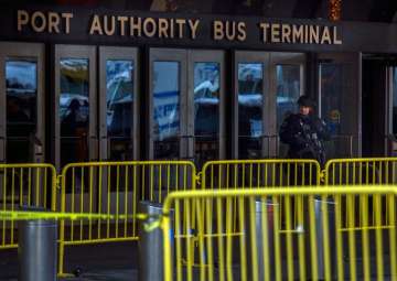 A police officer stands guard in front of Port Authority Bus Terminal in New York 