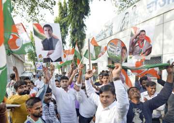 Congress party workers celebrate after Rahul Gandhi was declared elected as the party president, in Mumbai on Monday