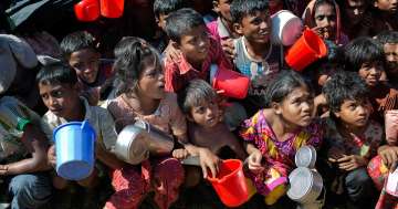 Rohingya Muslim children wait to receive food handouts at Thaingkhali refugee camp in Bangladesh. AP