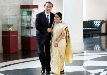 Sushma Swaraj and her Chinese counterpart Wang Yi exchange greetings before a meeting in New Delhi on Monday