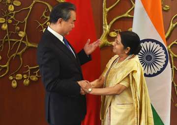 Sushma Swaraj and her Chinese counterpart Wang Yi exchange greetings in New Delhi