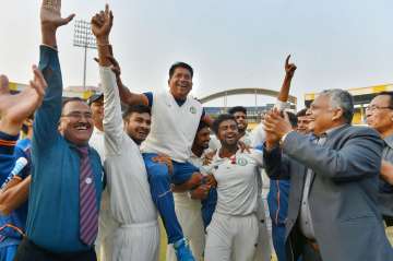 MP players picks Pandit on their shoulders after Ranji Trophy win.