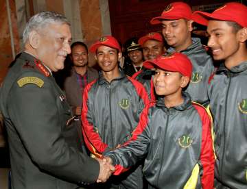  Army Chief Gen Bipin Rawat shakes hands with a youth, part of a group currently on a national integration tour, in New Delhi on Tuesday. 