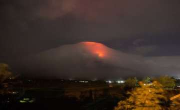 Orange glow seen at the cloud-shrouded crater of Mayon volcano at Legazpi city, Albay province, about 340 kilometers (210 miles) southeast of Manila, Philippines.