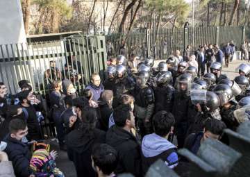 Anti-riot Iranian police prevent university students to join other protesters over Iran weak economy, in Tehran