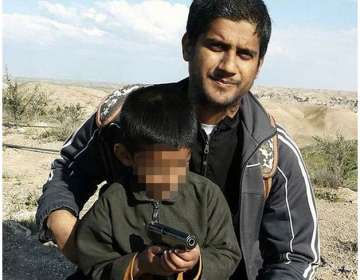 After escaping to Syria, Dhar posted an image online of himself holding a rifle, and his newborn and
