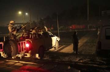 Security forces stand guard near the Intercontinental Hotel after a deadly attack in Kabul, Afghanistan, Saturday, Jan 20, 2018