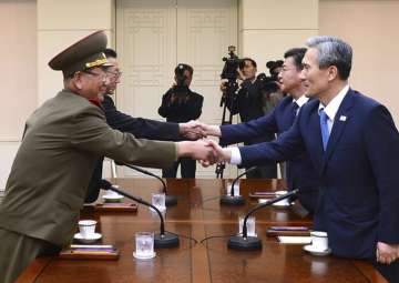 File pic - South Korean govt officials shake hands with North Korean officials