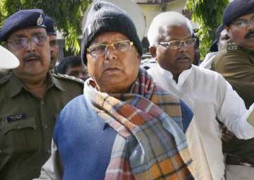 Lalu Yadav escorted by police officials after appearing at the special CBI court in Ranchi