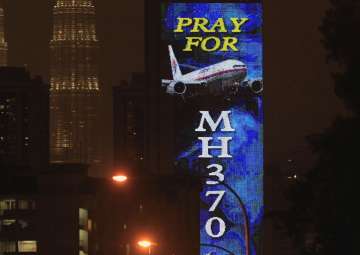 File pic - An office building is illuminated with LED lights displaying 'Pray for MH370' in Kuala Lumpur
