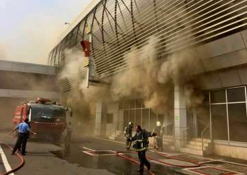 Fire-fighters dousing a fire that broke out at the Santacruz domestic airport in Mumbai on Saturday