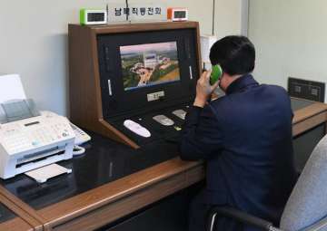 A South Korean government official checks the direct communications hotline to talk with the North Korean side at the border village of Panmunjom in Paju