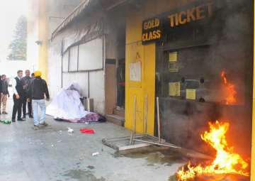 Smoke and fire emerge from Indira Theatre ticket booth after protesters attacked the counter against the release of film 'Padmaavat' in Jammu on Wednesday