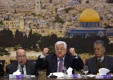 Palestinian President Mahmoud Abbas, center, speaks during a meeting with the Palestinian Central Council, a top decision-making body, at his headquarters in the West Bank city of Ramallah, Sunday