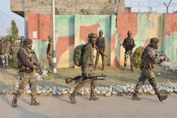 Security personnel take positions during a militants attack at Sunjwan Army camp in Jammu on Saturday.