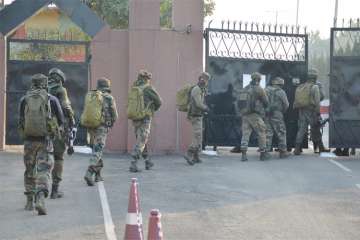 Security personnel take positions during a militants attack at Sunjwan Army camp in Jammu on Saturday. 