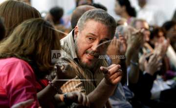 In this March 14, 2012 file photo, Fidel Castro Diaz-Balart, son of then Cuban leader Fidel Castro, speaks with an unidentified woman during the presentation of his father's book "Nuestro Deber es Luchar," or "Our Duty is to Fight," in Havana, Cuba.