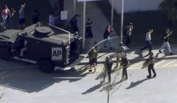 Students from the Marjory Stoneman Douglas High School in Parkland, Florida, evacuate the school following a shooting on Wednesday, February 14.