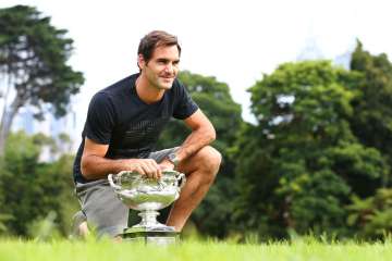 A file image of Roger Federer with the Australian Open trophy